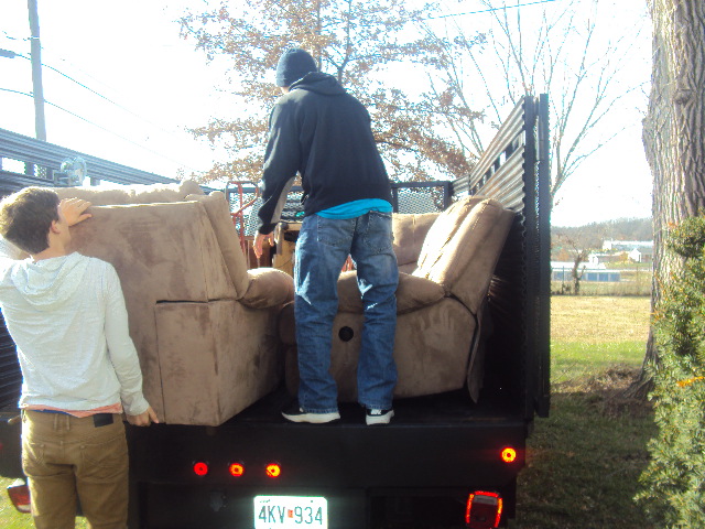 loading a coach into junk removal truck